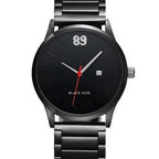 Black wristwatch with red second hand on a white background